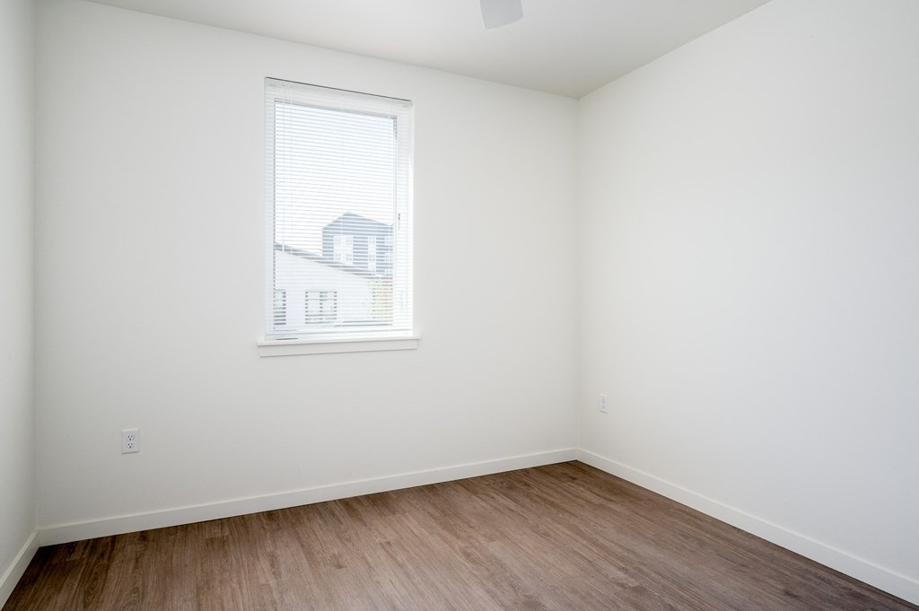 an empty room with white walls and a window