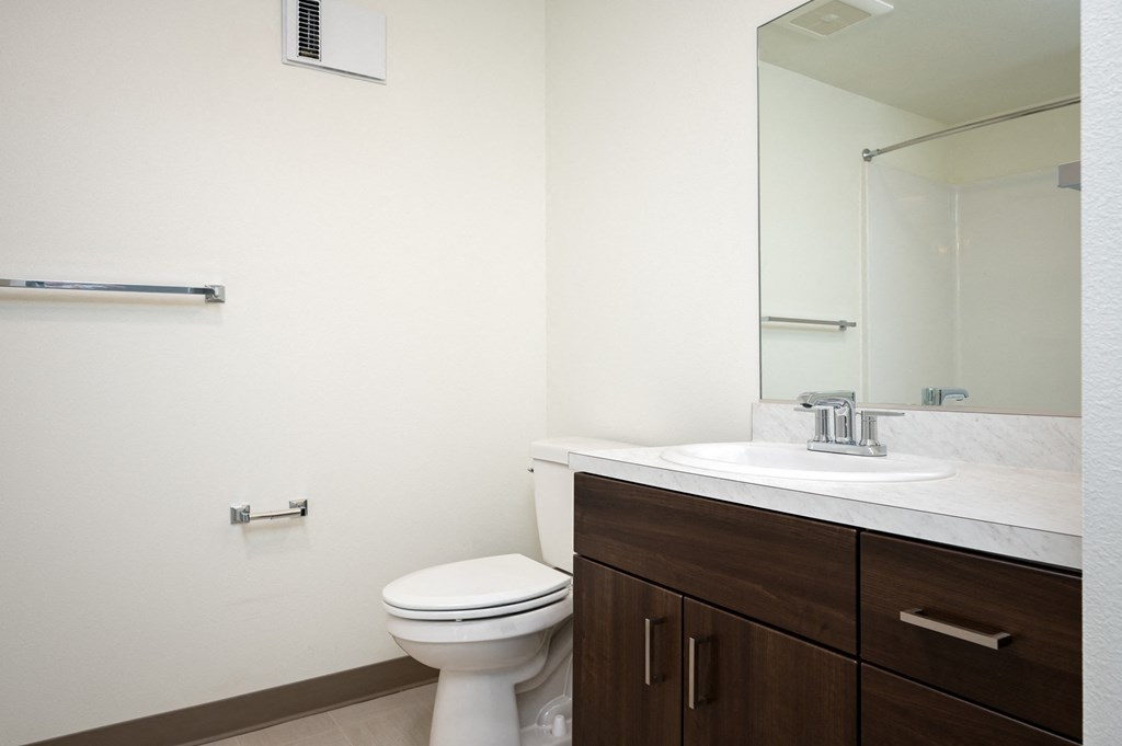 an empty bathroom with a toilet and a sink