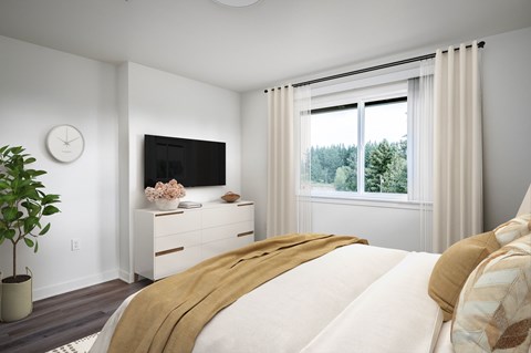 A bedroom with a large bed and a flat screen TV mounted on the wall.