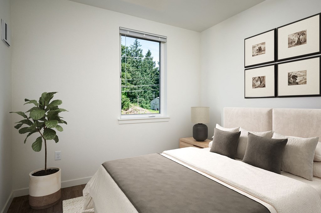 a bedroom with a large bed and a window