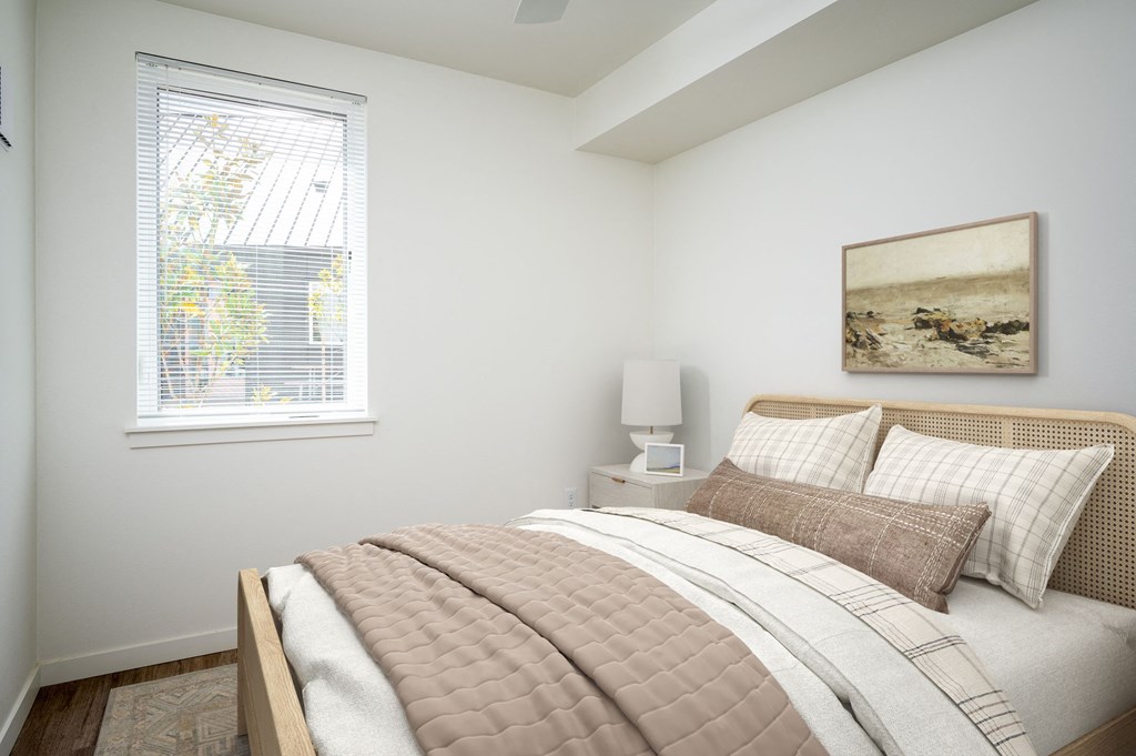 a bedroom with a bed and a window