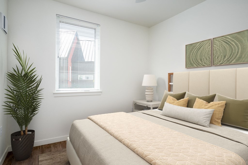 a bedroom with a large bed and a window