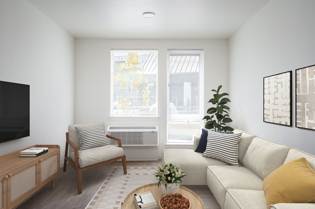 a living room with a couch and a chair and a television