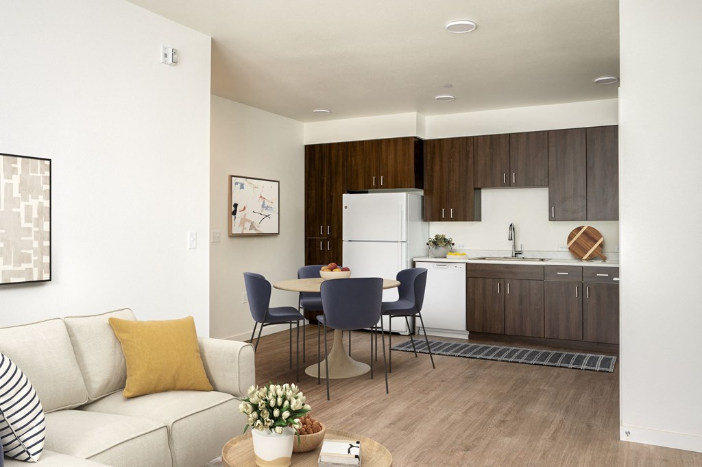 a living room and kitchen with a table and chairs and a couch