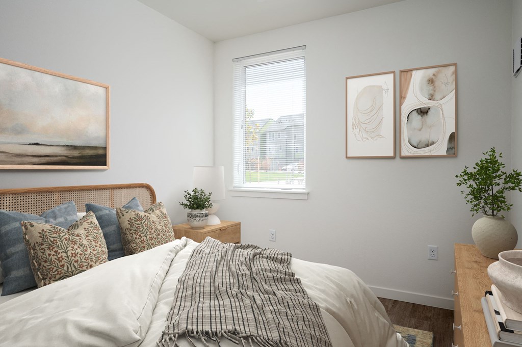 a bedroom with a bed and pictures on the wall