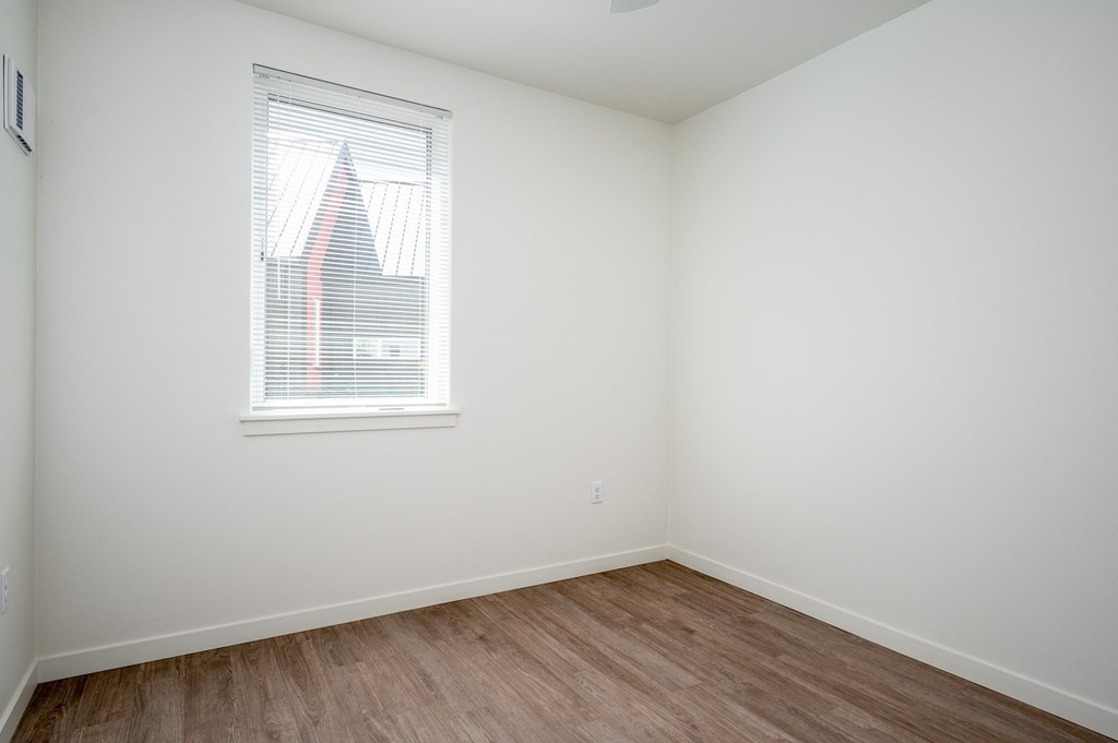 an empty room with white walls and a window