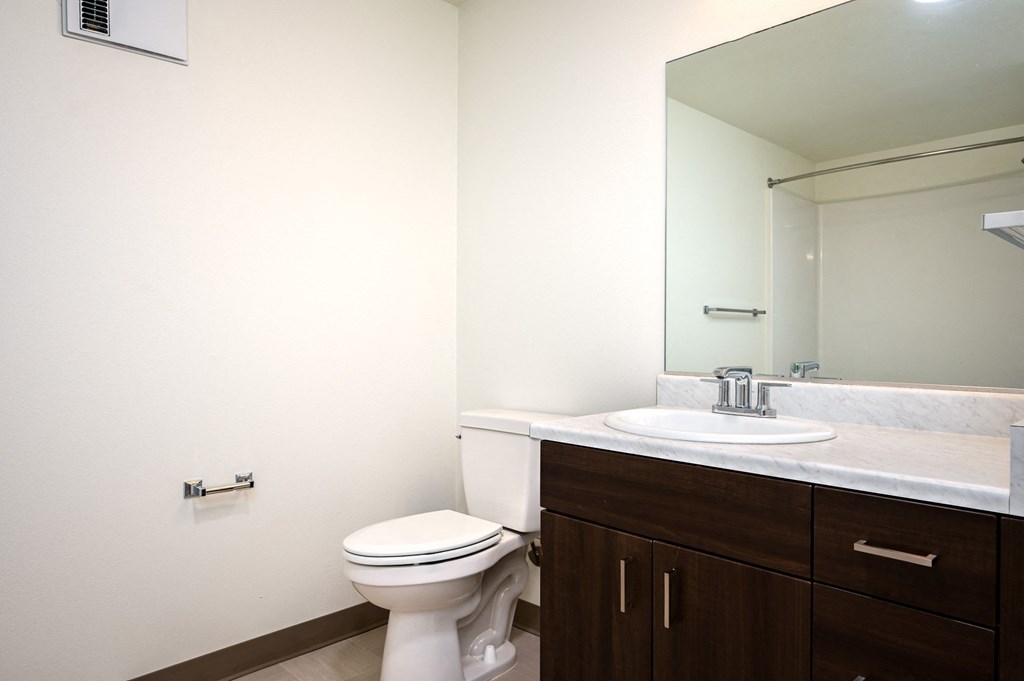 an empty bathroom with a toilet and a sink