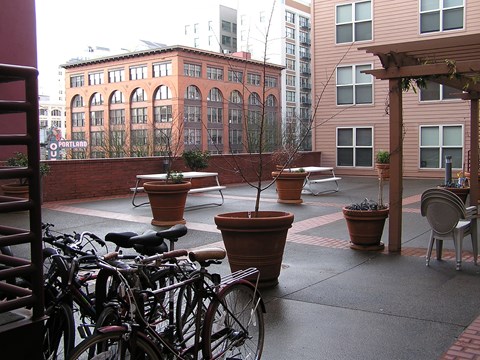 A patio with a bicycle and a table.
