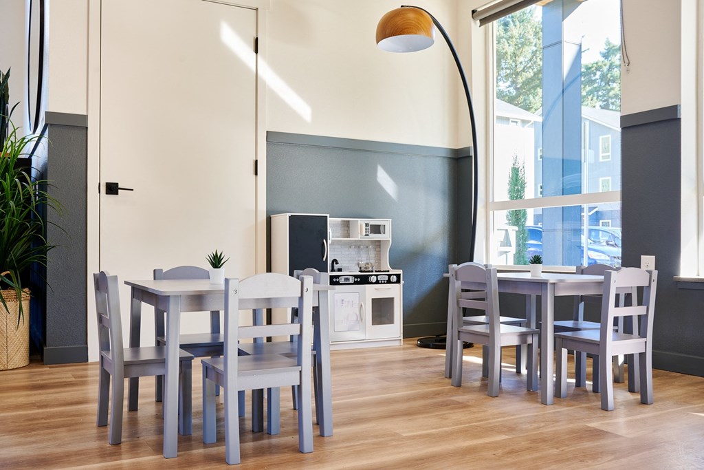 a dining room with a table and chairs and a kitchen