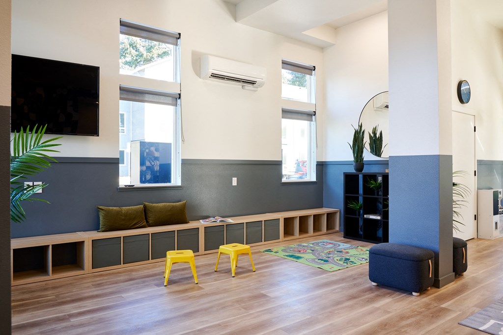 a multipurpose room with a seating area and a tv