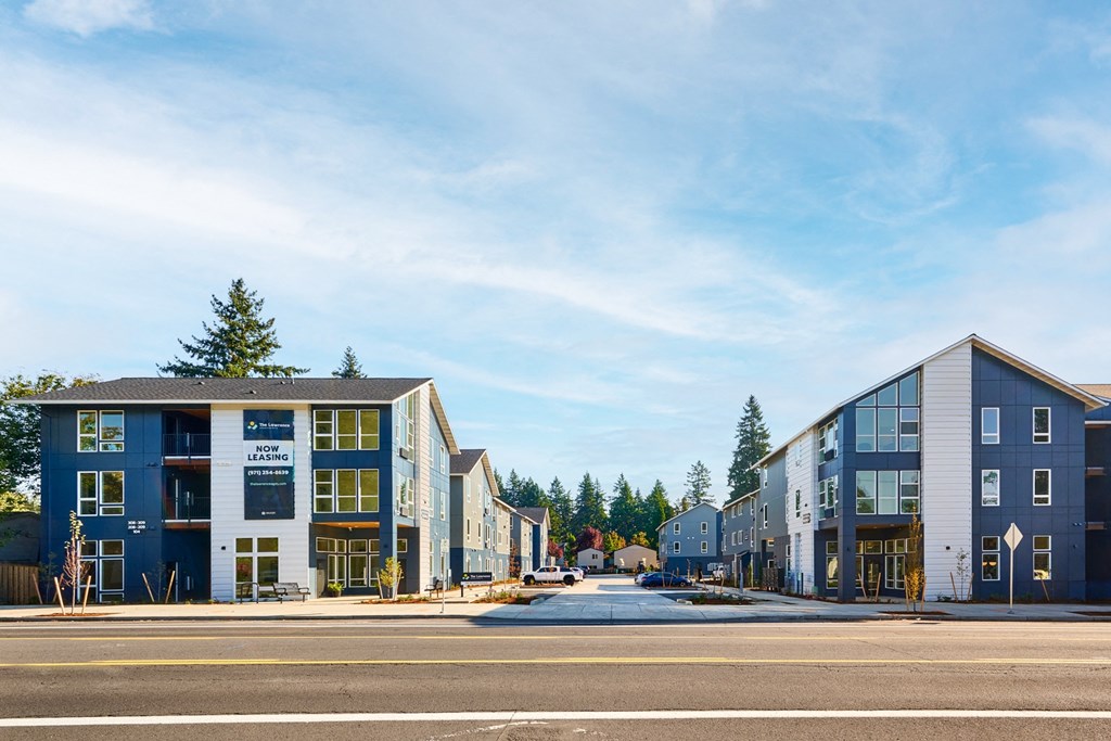 a row of new apartment buildings on the side of a street
