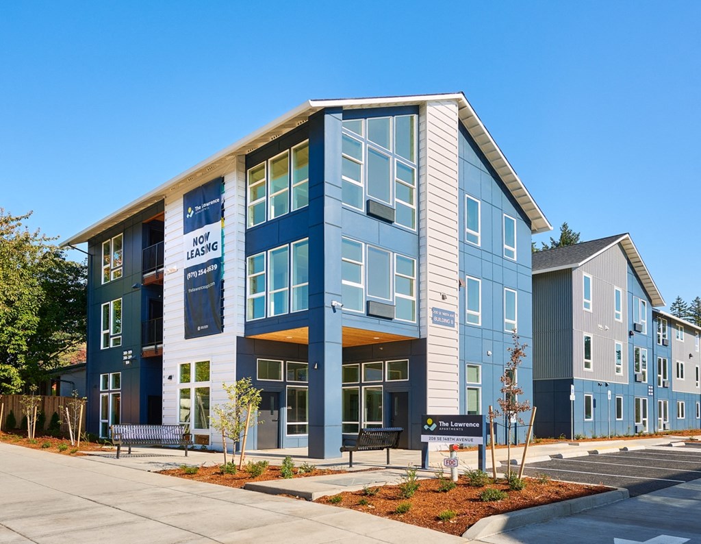 a blue and white building with a sidewalk in front of it