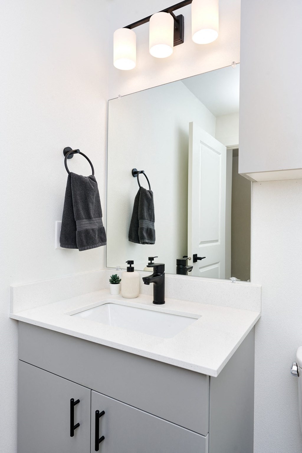 a white bathroom with a sink and a mirror