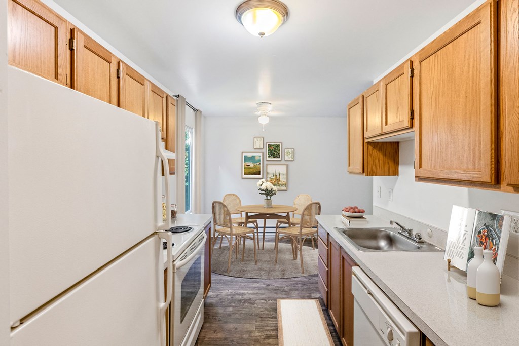 a kitchen and dining room with a table and chairs