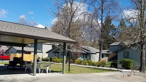 a patio with a table and chairs in front of houses