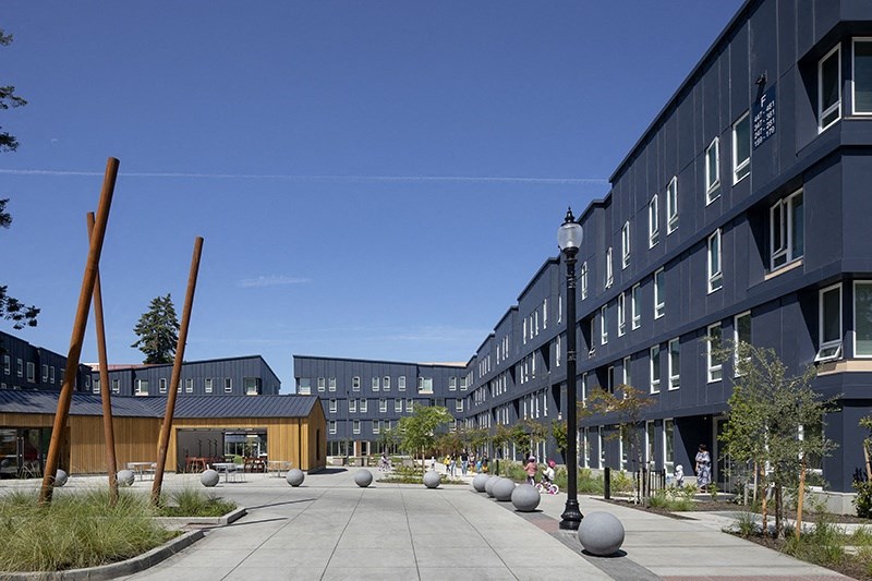 a courtyard in front of a building with a blue sky in the background