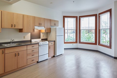 A kitchen with wooden cabinets and a white refrigerator.