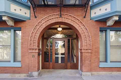 A red brick building with a large arched doorway.