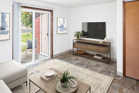 a living room with white walls and a sliding glass door