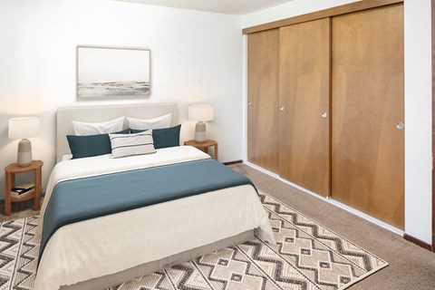 a bedroom with a bed and a wardrobe