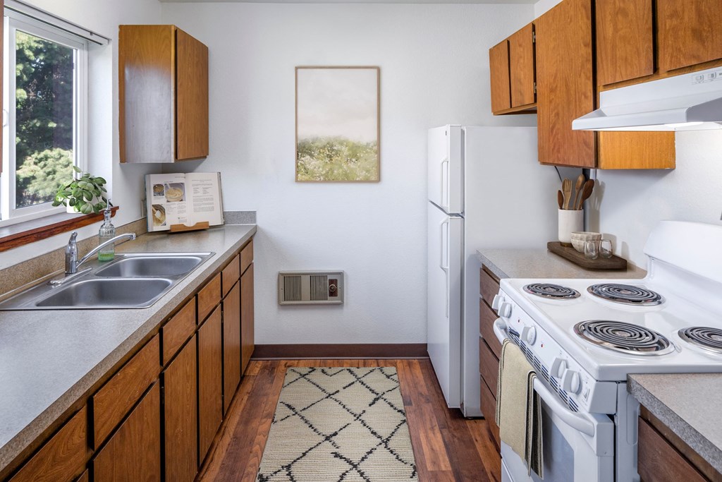 a kitchen with white appliances and wooden cabinets