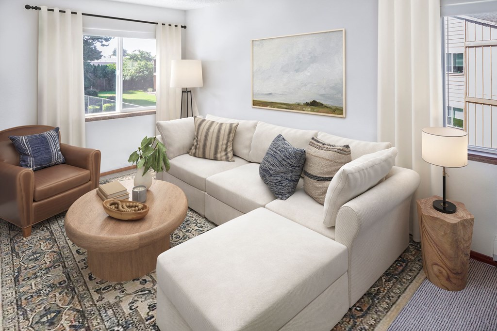 a living room filled with furniture and a large window