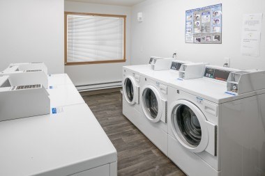 A row of washing machines in a laundromat.