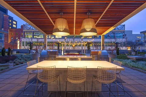 a dining area with a table and chairs under a roof