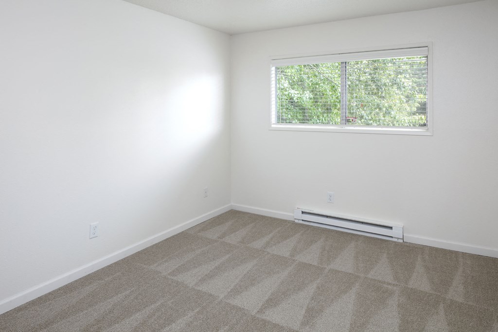 a small room with white walls and a window