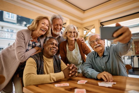 A group of seniors are taking a selfie together.