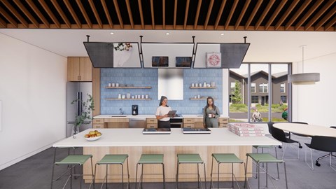 Two people are standing behind a counter in a modern kitchen.