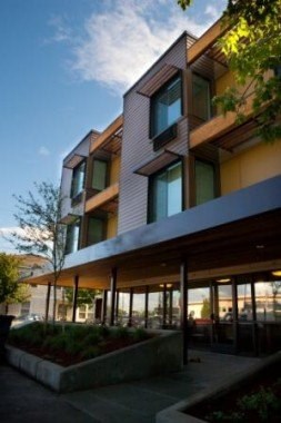 A modern building with a large front yard.