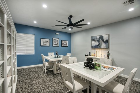 A dining room with a white table and chairs.