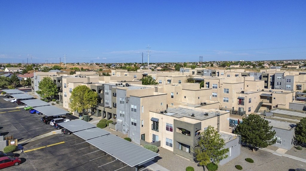 A parking lot in front of apartment buildings.