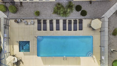 A rectangular pool with a blue tiled border and a white tiled floor.