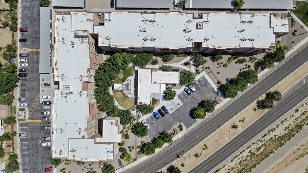 An aerial view of a parking lot and buildings.