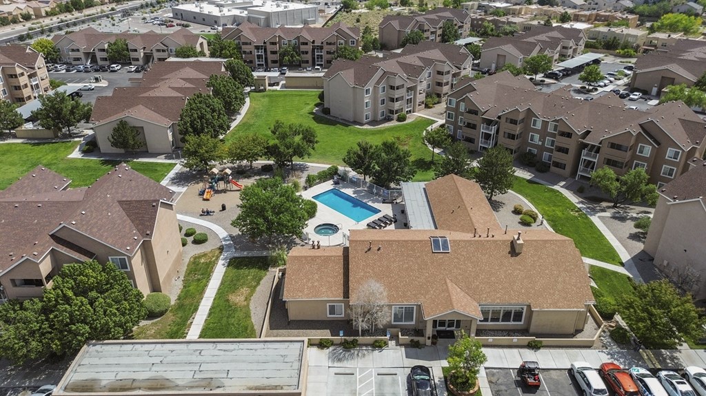 A large apartment complex with a pool in the middle.
