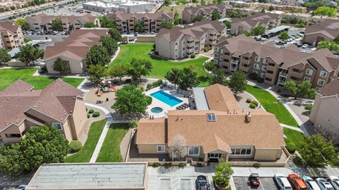 A large apartment complex with a pool in the middle.
