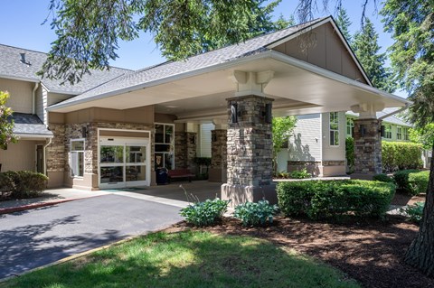 A house with a covered entrance and a stone pillar.