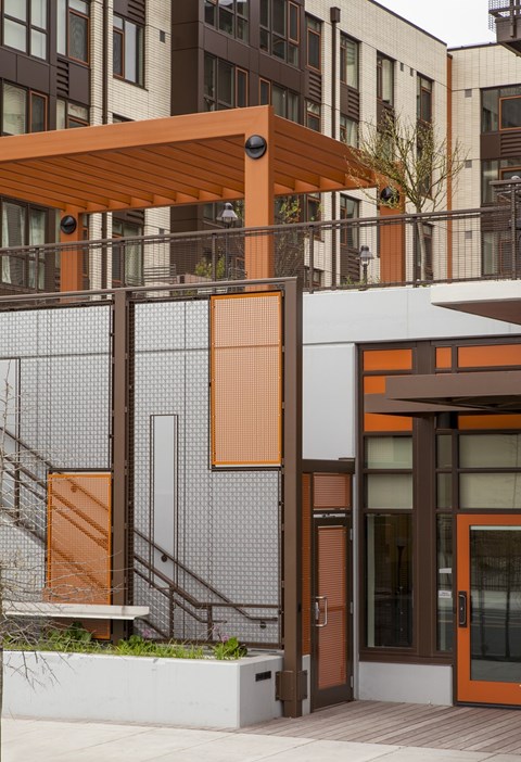 A building with a brown and white exterior and a brown awning.