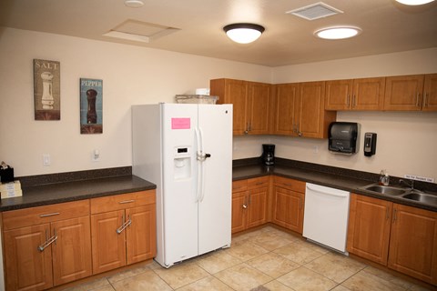 a kitchen with wooden cabinets and a white refrigerator