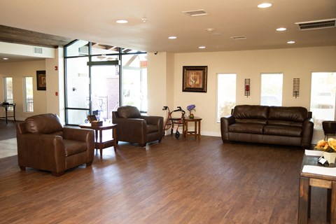 a living room with leather couches and chairs