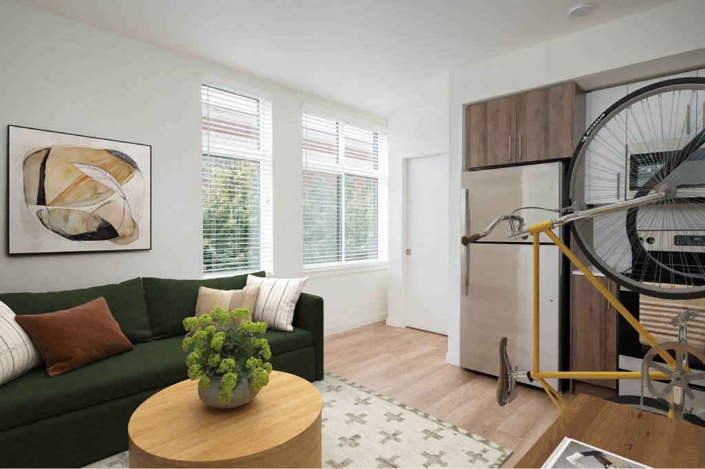 a living room with a green couch and a bicycle in the corner
