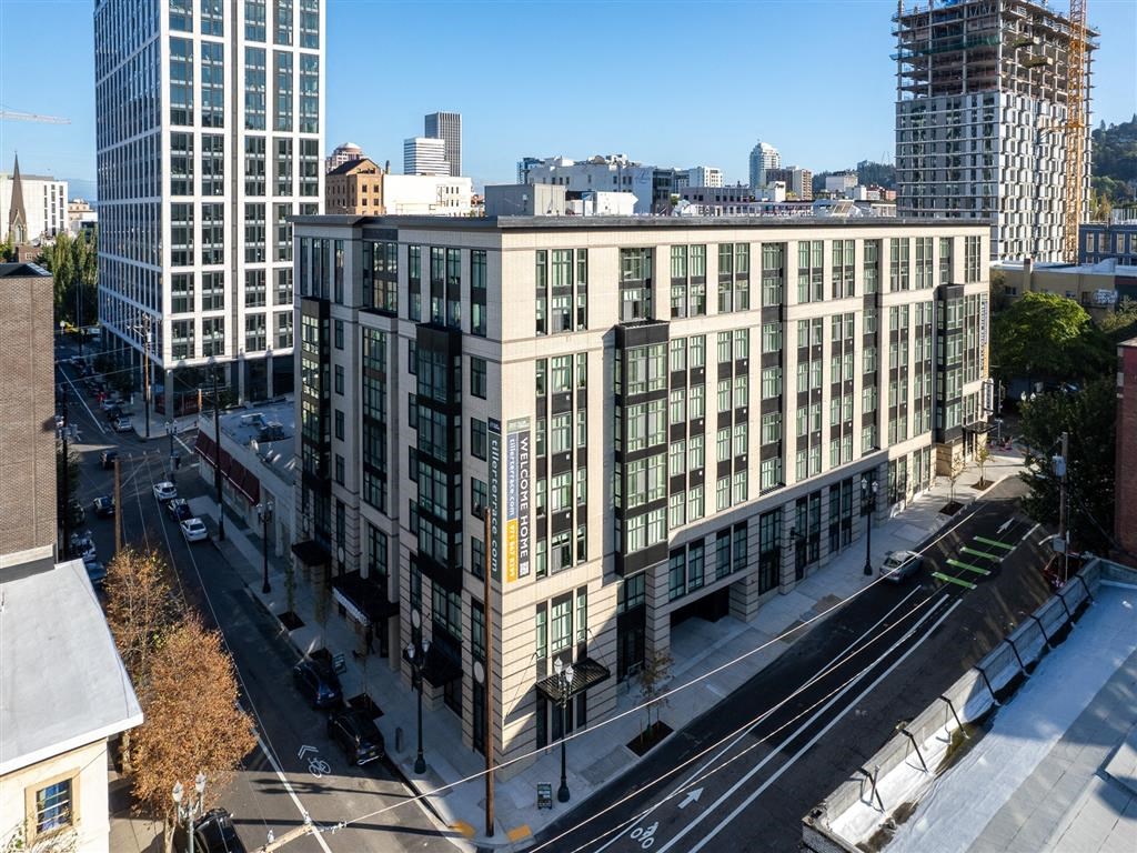 an aerial view of a large white building in the city