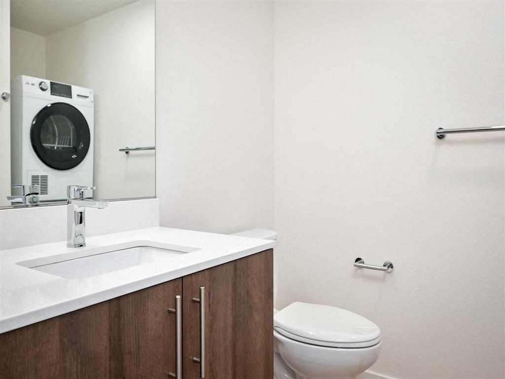 a bathroom with a toilet and a sink and a mirror