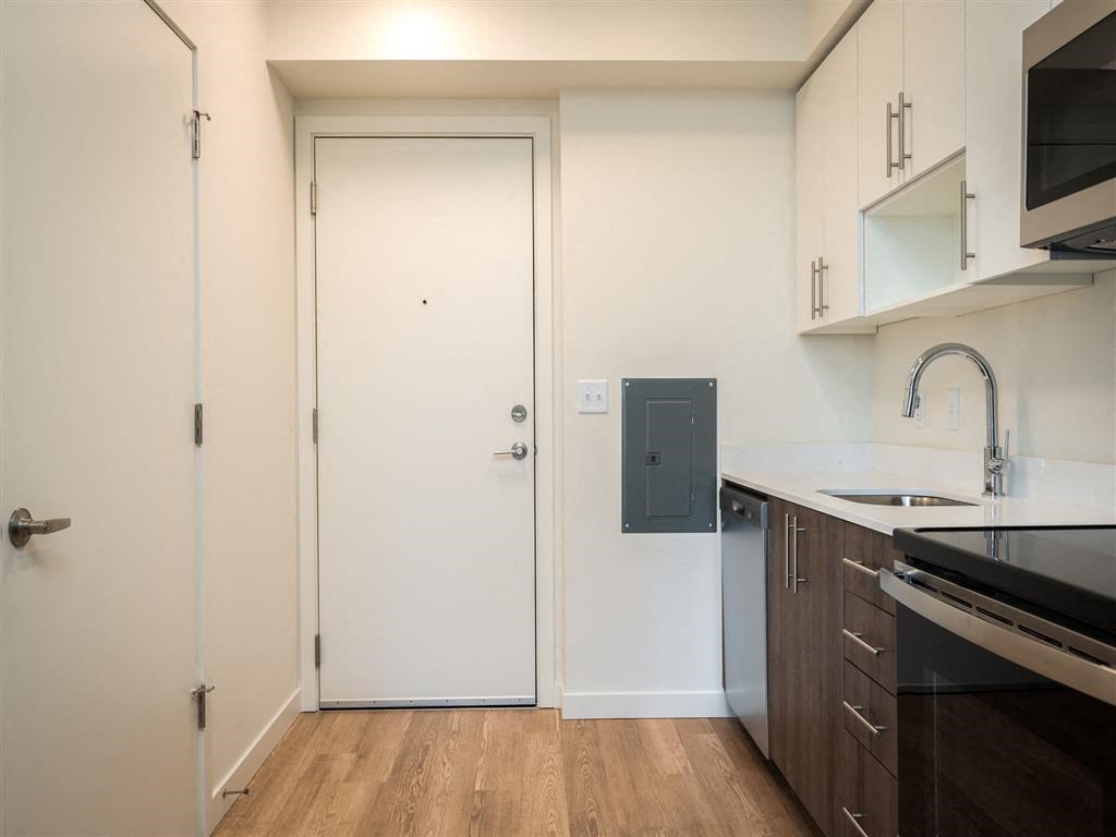 a kitchen with a sink and a door