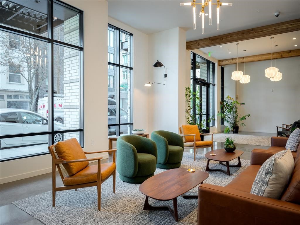 a living room with couches and chairs and a large window
