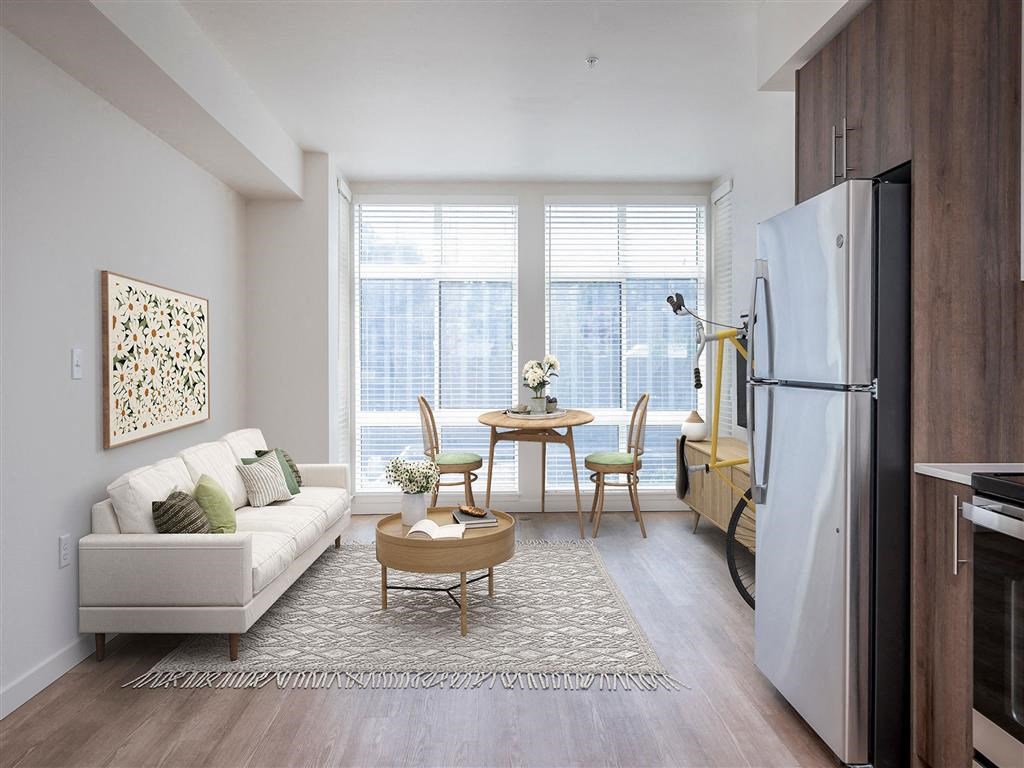 a living room with a couch and a table and a refrigerator