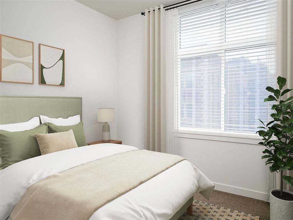 a bedroom with a bed and a large window