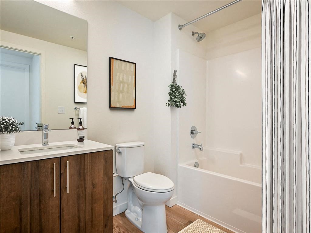 a bathroom with a toilet and a bath tub
